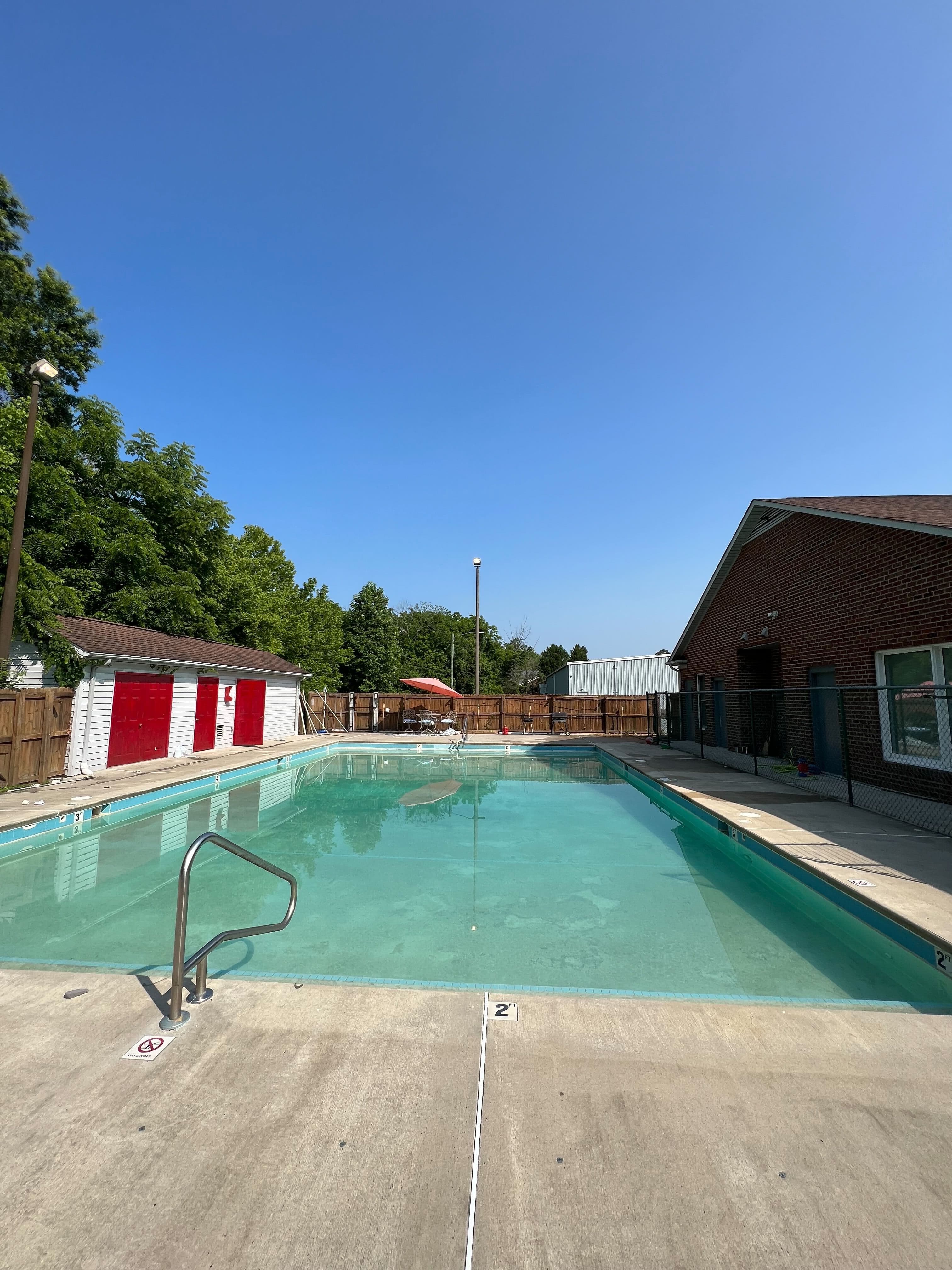 Clean blue backyard pool after algae treatment